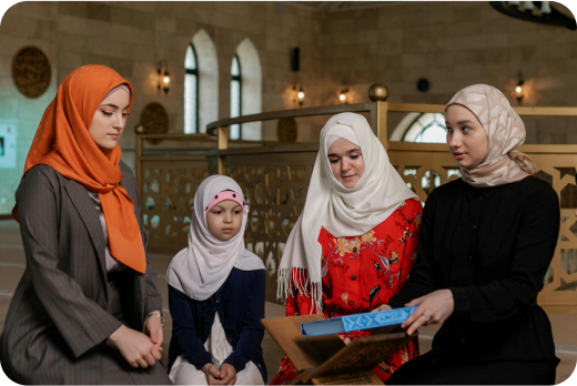Students revising Quran lesson in groups